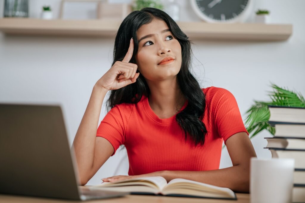 young-woman-working-with-laptop-desk-thinking-about-solving-problems